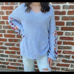 Light blue v-neck sweater with flowers